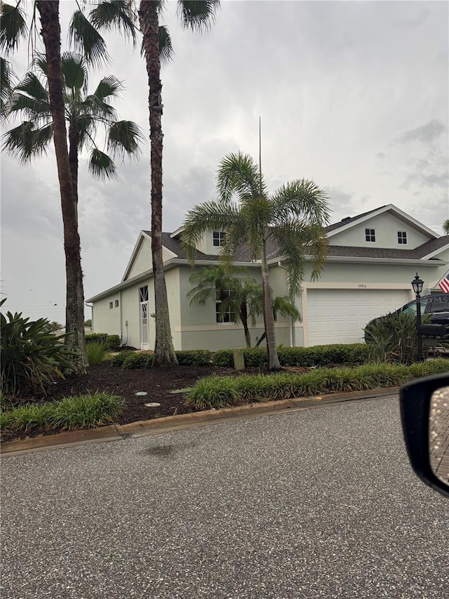 24016 Buckingham Way, Punta Gorda, FL 33980 - view of front of property with a garage and stucco siding