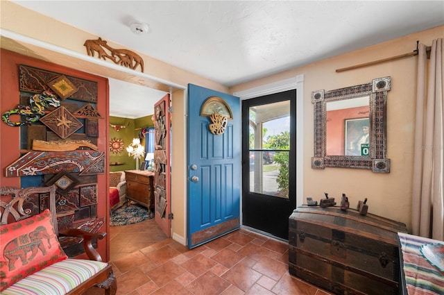 611 Bonita Ct, Punta Gorda, FL 33950 - foyer featuring stone tile floors and baseboards