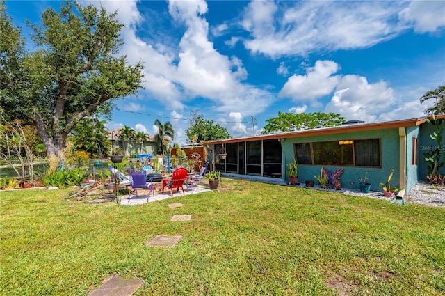 611 Bonita Ct, Punta Gorda, FL 33950 - view of grassy yard featuring a sunroom and a patio