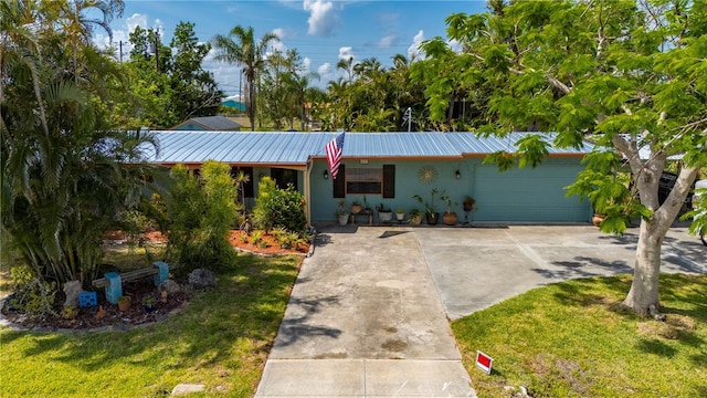 611 Bonita Ct, Punta Gorda, FL 33950 - single story home with driveway, a garage, metal roof, stucco siding, and a front yard