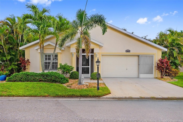 1812 Birmingham Blvd, Punta Gorda, FL 33980 - view of front facade featuring stucco siding, concrete driveway, an attached garage, and a front yard