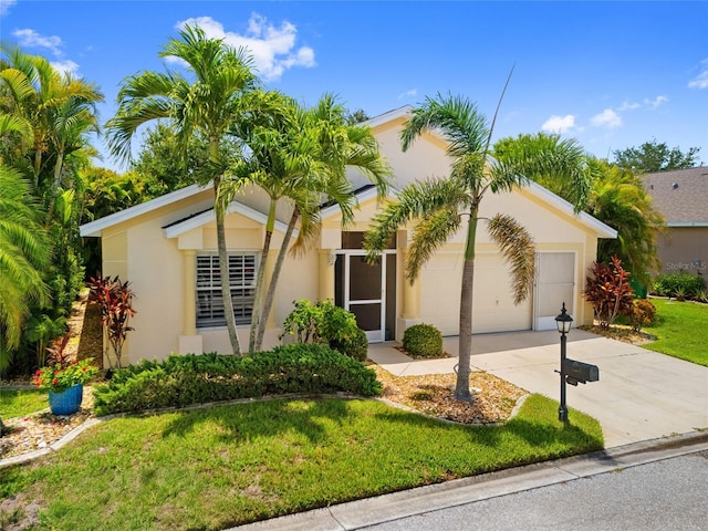 1812 Birmingham Blvd, Punta Gorda, FL 33980 - view of front of property featuring an attached garage, concrete driveway, stucco siding, and a front yard