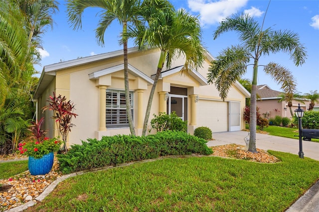 1812 Birmingham Blvd, Punta Gorda, FL 33980 - view of front of home with stucco siding, concrete driveway, a garage, and a front yard
