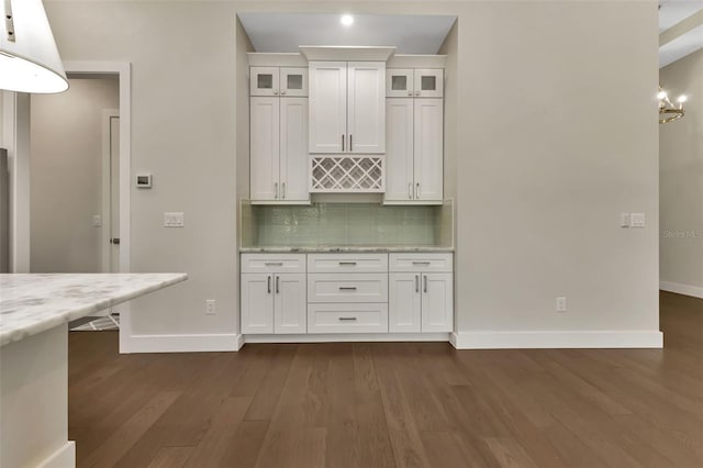 5451 Prime Ter, North Port, FL 34286 - kitchen featuring baseboards, white cabinets, dark wood-style floors, and decorative backsplash