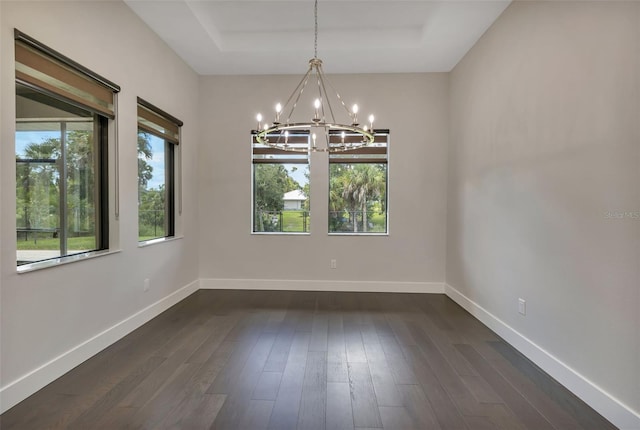 5451 Prime Ter, North Port, FL 34286 - unfurnished room with a chandelier, a raised ceiling, dark wood-type flooring, and baseboards