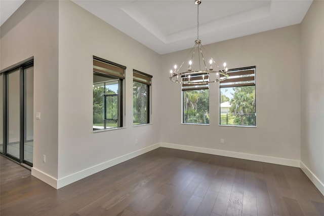 5451 Prime Ter, North Port, FL 34286 - unfurnished room featuring a chandelier, healthy amount of natural light, dark wood-style flooring, and baseboards