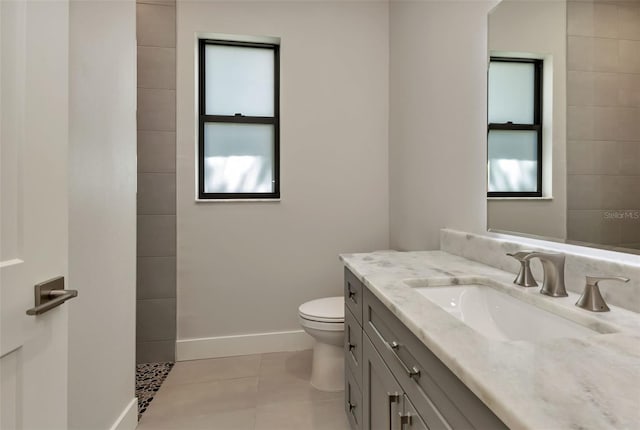 5451 Prime Ter, North Port, FL 34286 - bathroom featuring toilet, vanity, baseboards, tile patterned flooring, and a tile shower