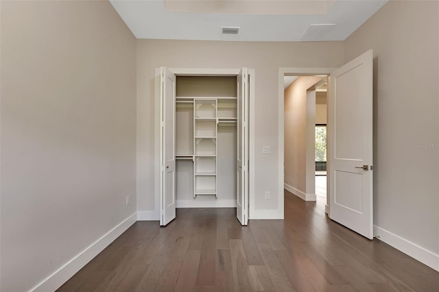 5451 Prime Ter, North Port, FL 34286 - unfurnished bedroom with dark wood-type flooring, baseboards, and a closet
