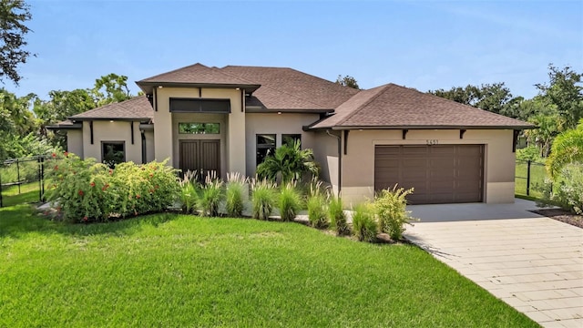5451 Prime Ter, North Port, FL 34286 - view of front of property featuring an attached garage, driveway, stucco siding, and roof with shingles