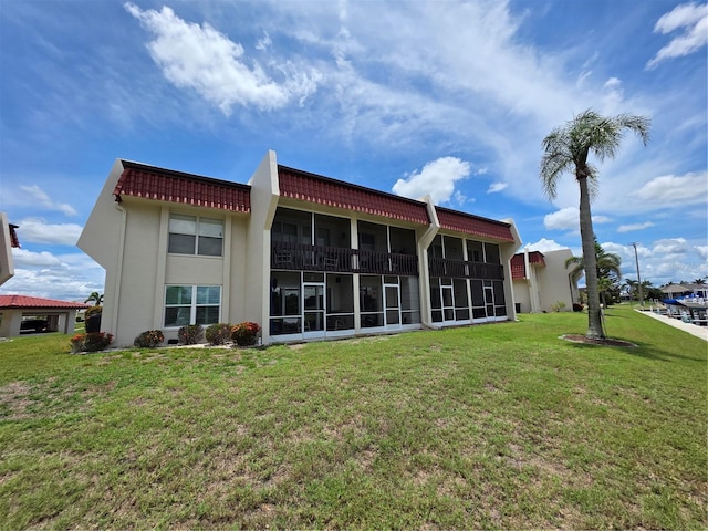 311 Garvin St Unit 405B, Punta Gorda, FL 33950 - rear view of house featuring a yard, a sunroom, and stucco siding