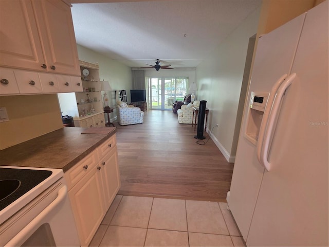 311 Garvin St Unit 405B, Punta Gorda, FL 33950 - kitchen with white appliances, ceiling fan, dark countertops, light wood-style flooring, and open floor plan