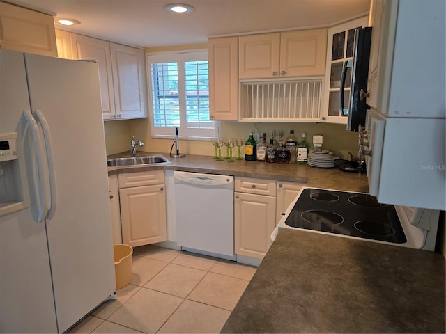 311 Garvin St Unit 405B, Punta Gorda, FL 33950 - kitchen with white appliances, a sink, light tile patterned flooring, white cabinetry, and recessed lighting