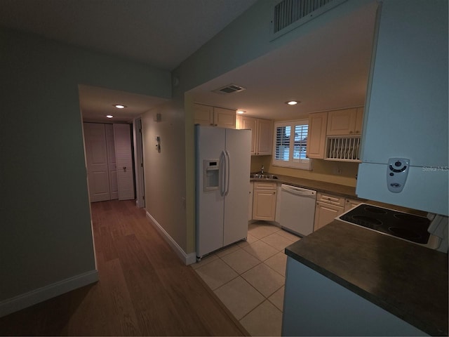 311 Garvin St Unit 405B, Punta Gorda, FL 33950 - kitchen with white appliances, a sink, dark countertops, white cabinetry, and recessed lighting