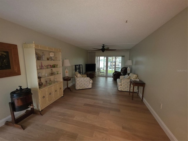 311 Garvin St Unit 405B, Punta Gorda, FL 33950 - living area featuring light wood-type flooring, ceiling fan, and baseboards