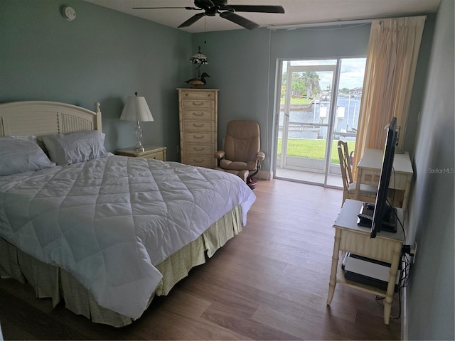 311 Garvin St Unit 405B, Punta Gorda, FL 33950 - bedroom featuring access to exterior, wood finished floors, baseboard heating, and ceiling fan