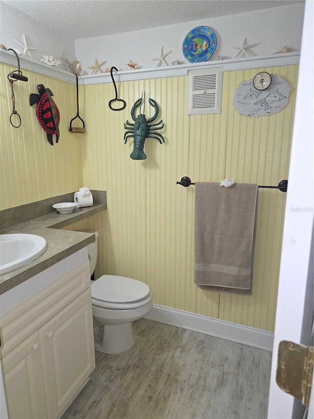311 Garvin St Unit 405B, Punta Gorda, FL 33950 - bathroom featuring vanity, wood finished floors, toilet, and a textured ceiling