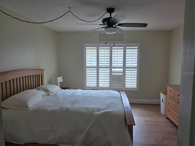 311 Garvin St Unit 405B, Punta Gorda, FL 33950 - bedroom featuring wood finished floors, a textured ceiling, baseboards, and ceiling fan
