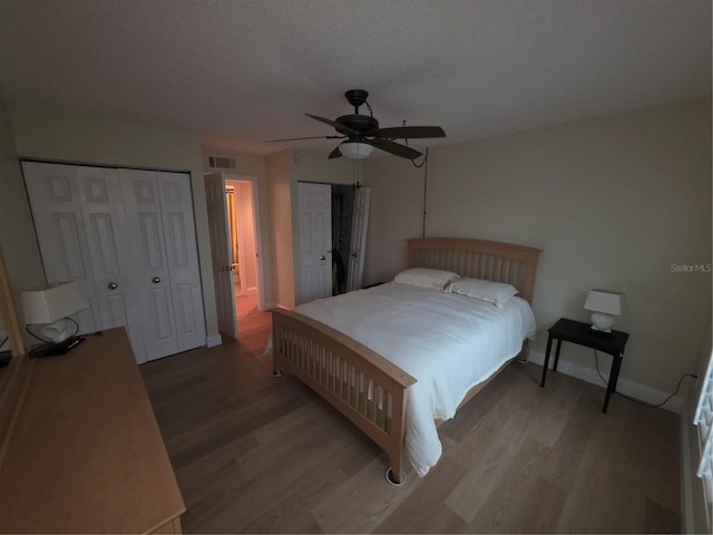 311 Garvin St Unit 405B, Punta Gorda, FL 33950 - bedroom with multiple closets, light wood finished floors, baseboards, and ceiling fan