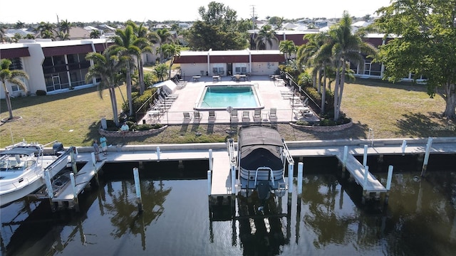 311 Garvin St Unit 405B, Punta Gorda, FL 33950 - back of house featuring boat lift, a water view, a lawn, and a community pool