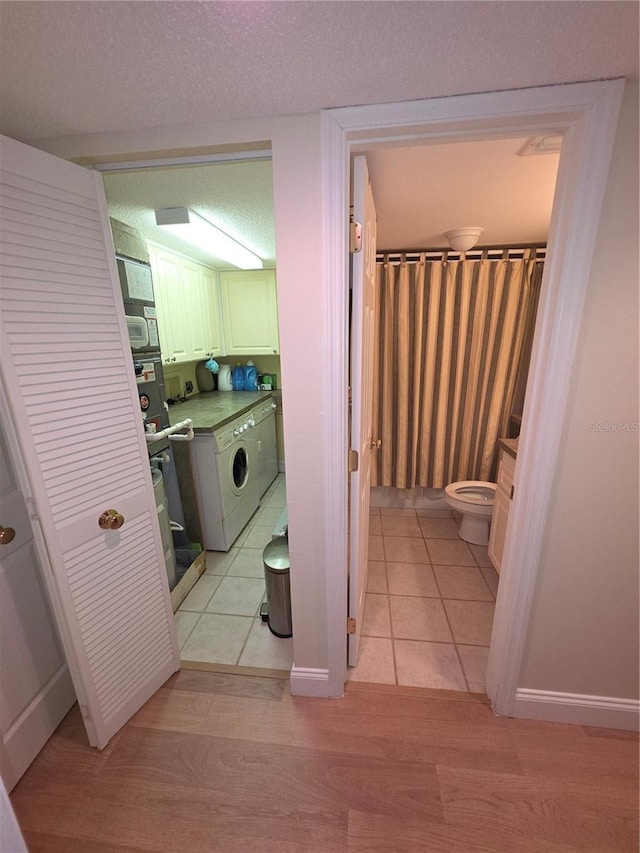 311 Garvin St Unit 405B, Punta Gorda, FL 33950 - bathroom with toilet, washing machine and dryer, and wood finished floors