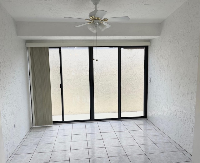 13100 S Mccall Rd Unit 125, Port Charlotte, FL 33981 - empty room featuring a textured wall, ceiling fan, a textured ceiling, and light tile patterned floors