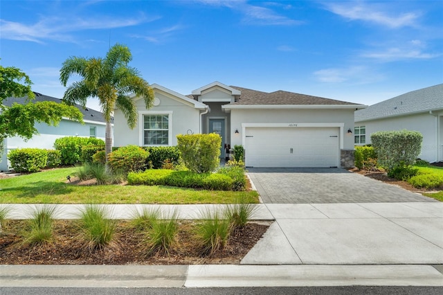 16176 Lotus Way, Punta Gorda, FL 33982 - ranch-style home featuring stucco siding, decorative driveway, and an attached garage