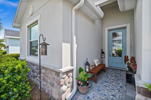 16176 Lotus Way, Punta Gorda, FL 33982 - doorway to property featuring stucco siding and stone siding