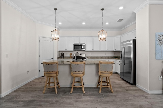16176 Lotus Way, Punta Gorda, FL 33982 - kitchen with appliances with stainless steel finishes, crown molding, an island with sink, baseboards, and recessed lighting