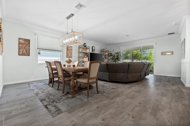 16176 Lotus Way, Punta Gorda, FL 33982 - dining area with a chandelier, crown molding, wood finished floors, and baseboards