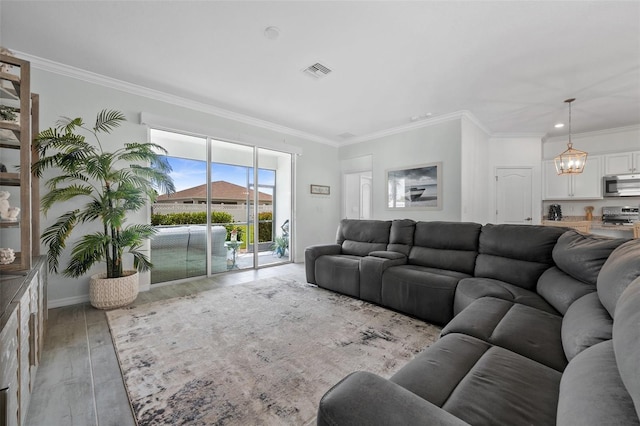 16176 Lotus Way, Punta Gorda, FL 33982 - living room featuring a chandelier, light wood-style flooring, crown molding, recessed lighting, and baseboards