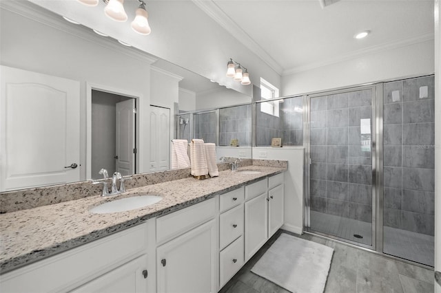 16176 Lotus Way, Punta Gorda, FL 33982 - full bathroom featuring double vanity, a shower stall, and ornamental molding