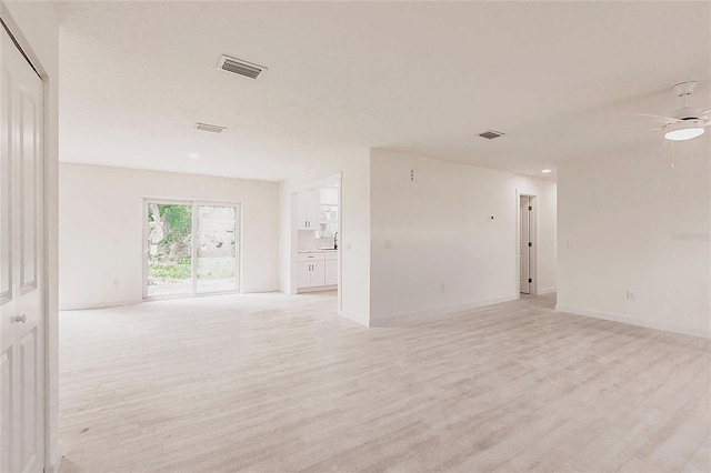 37 Oakland Hills Ct, Rotonda West, FL 33947 - empty room featuring light wood-style flooring, a ceiling fan, a sink, baseboards, and recessed lighting