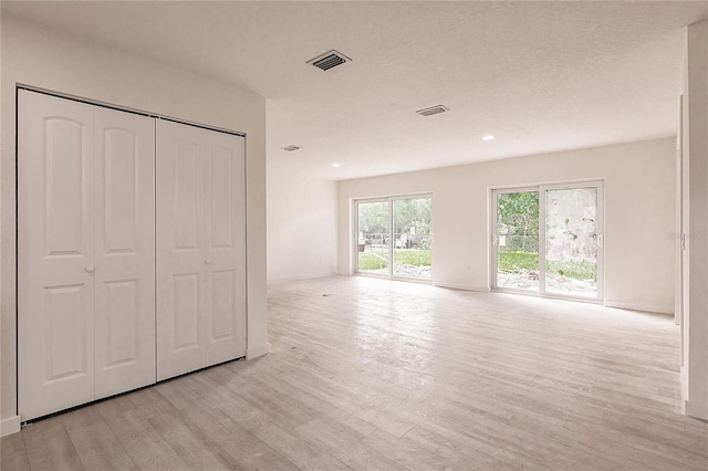 37 Oakland Hills Ct, Rotonda West, FL 33947 - unfurnished bedroom featuring light wood-style floors, access to outside, recessed lighting, and a closet