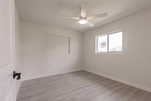 37 Oakland Hills Ct, Rotonda West, FL 33947 - spare room with light wood finished floors, a ceiling fan, and baseboards