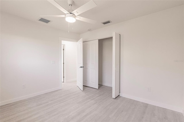 37 Oakland Hills Ct, Rotonda West, FL 33947 - unfurnished bedroom featuring light wood-style floors, baseboards, a closet, and a ceiling fan