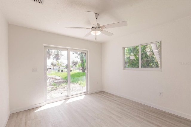 37 Oakland Hills Ct, Rotonda West, FL 33947 - unfurnished room with plenty of natural light, light wood finished floors, ceiling fan, and baseboards