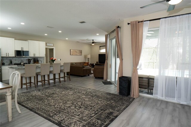 6794 Loffreda Ave, North Port, FL 34291 - living area featuring a ceiling fan, light wood-style floors, and recessed lighting