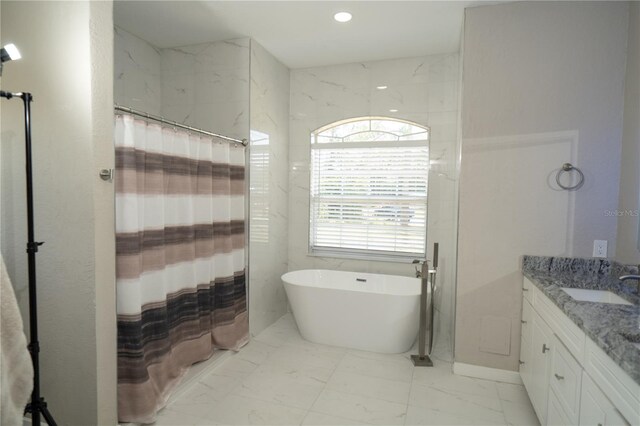 6794 Loffreda Ave, North Port, FL 34291 - full bathroom with marble look tile flooring, vanity, a freestanding tub, a shower with curtain, and recessed lighting
