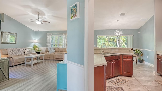237 Strasburg Dr, Port Charlotte, FL 33954 - kitchen featuring vaulted ceiling, a ceiling fan, open floor plan, and plenty of natural light