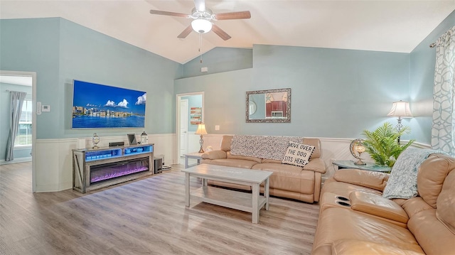 237 Strasburg Dr, Port Charlotte, FL 33954 - living room with ceiling fan, wainscoting, wood finished floors, a glass covered fireplace, and high vaulted ceiling