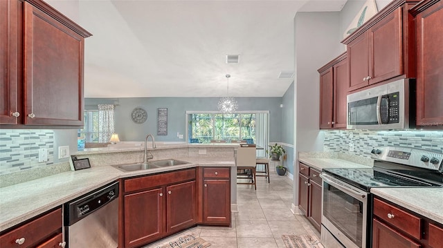 237 Strasburg Dr, Port Charlotte, FL 33954 - kitchen with appliances with stainless steel finishes, light countertops, a peninsula, and healthy amount of natural light