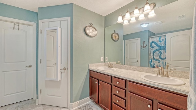 237 Strasburg Dr, Port Charlotte, FL 33954 - bathroom with double vanity, tile patterned flooring, a textured wall, and a shower with shower curtain