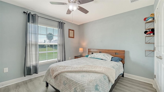 237 Strasburg Dr, Port Charlotte, FL 33954 - bedroom featuring wood finished floors, multiple windows, and a ceiling fan