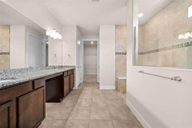 42346 Waterfront Way, Punta Gorda, FL 33982 - bathroom with double vanity, walk in shower, tile patterned flooring, a spacious closet, and recessed lighting