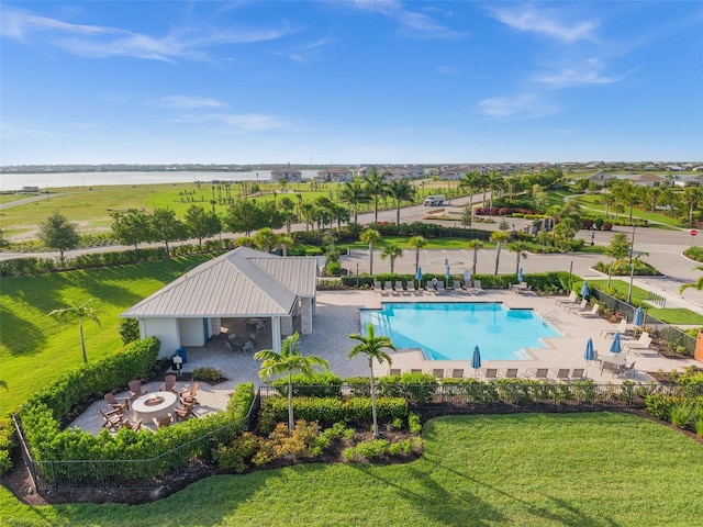 42346 Waterfront Way, Punta Gorda, FL 33982 - community pool with an outdoor fire pit, a patio area, a water view, and a lawn