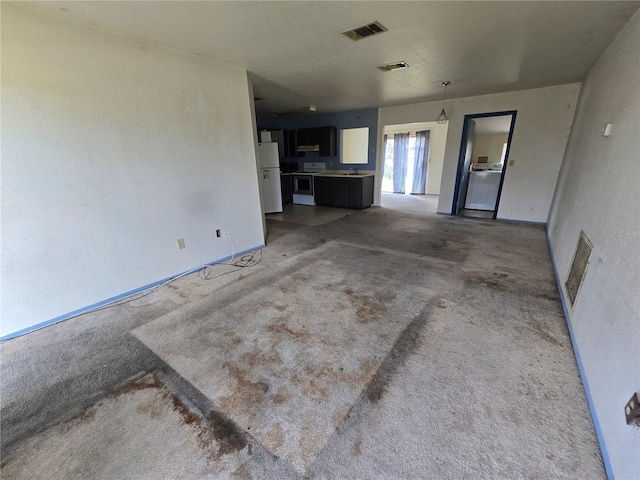 4424 Baroda Ave, North Port, FL 34287 - unfurnished living room with carpet flooring, baseboards, and washer / clothes dryer