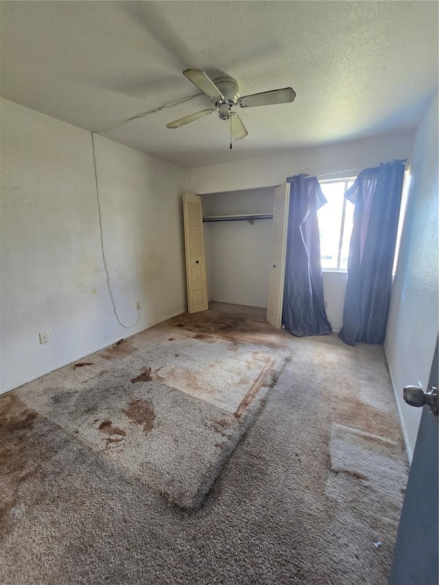 4424 Baroda Ave, North Port, FL 34287 - unfurnished bedroom featuring carpet, a textured ceiling, ceiling fan, and a closet