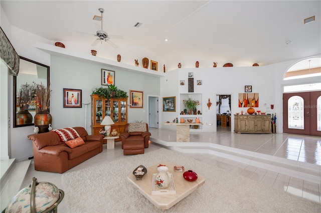 17400 White Water Ct, Punta Gorda, FL 33982 - living area featuring tile patterned flooring, ceiling fan, french doors, and high vaulted ceiling