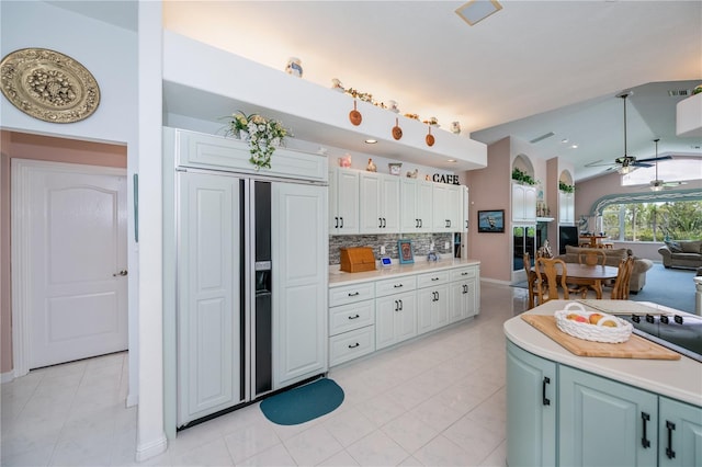 17400 White Water Ct, Punta Gorda, FL 33982 - kitchen with paneled built in fridge, ceiling fan, arched walkways, light countertops, and lofted ceiling