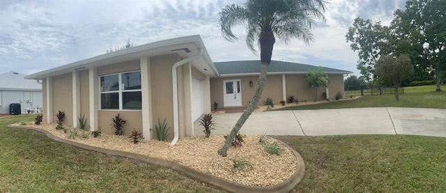 26129 Madras Ct, Punta Gorda, FL 33983 - view of front facade with stucco siding, a front yard, driveway, and a garage